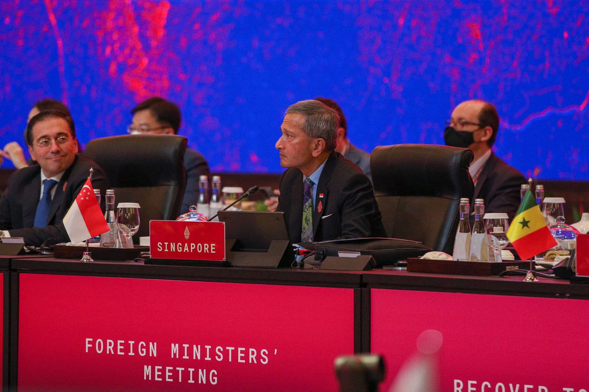 Group of seven people in business attire, standing beneath the "ERBER Group" logo and monitors showing produce.